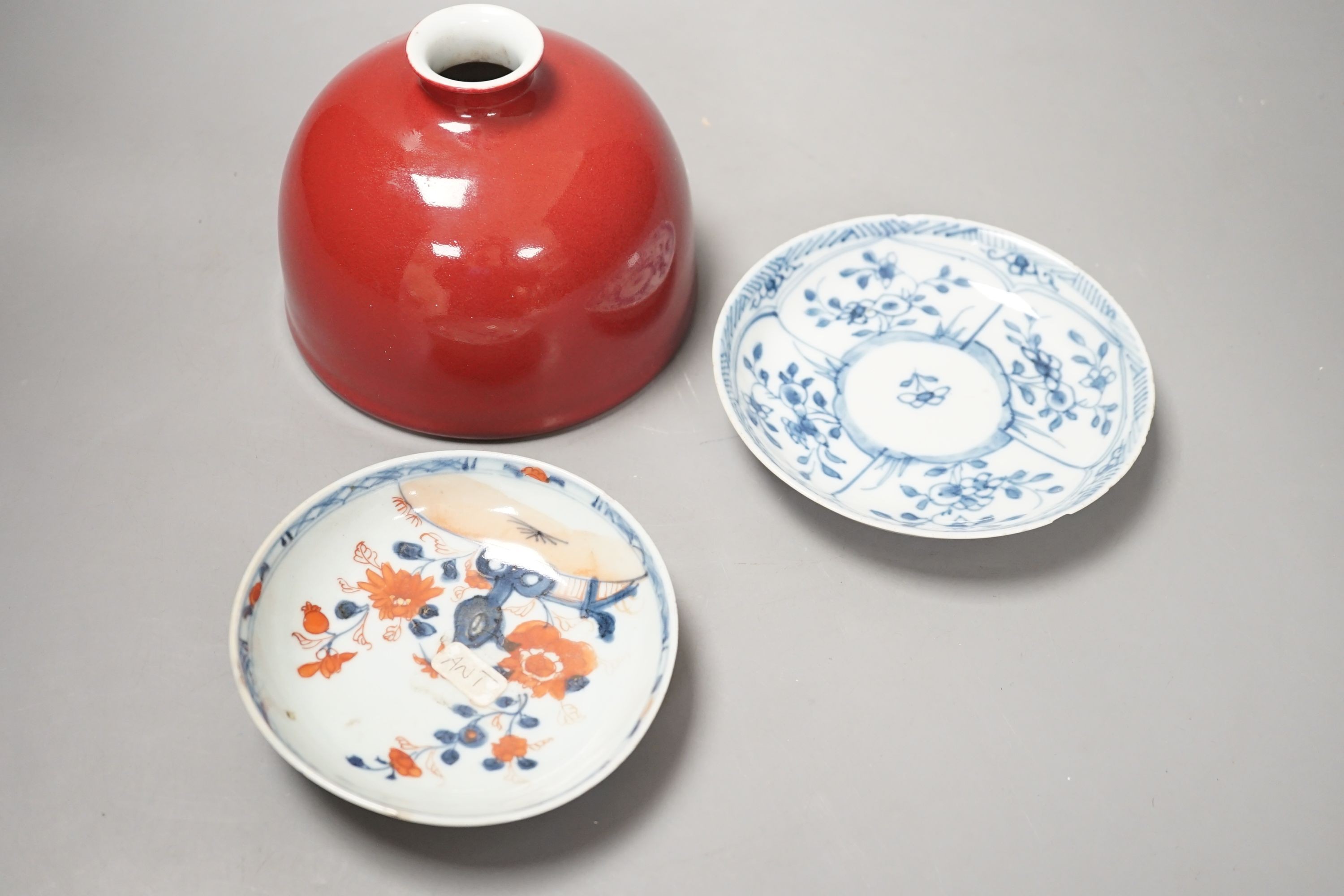 An 18th century Chinese Imari saucer, another blue and white saucer and sang de boeuf brush washer. Tallest 10cm